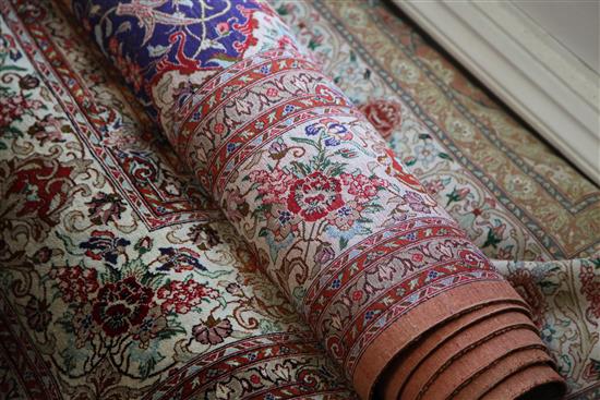 A Persian silk rug, 9ft 8in by 6ft 5in.